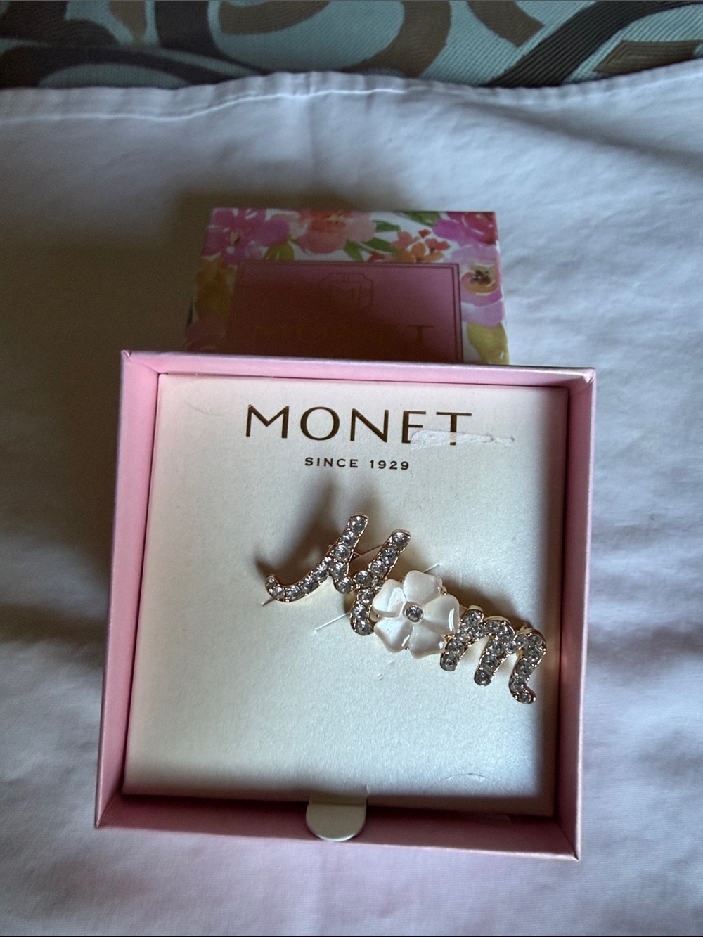 Monet Gold Tone Crystal “Mom” Brooch with White Flower